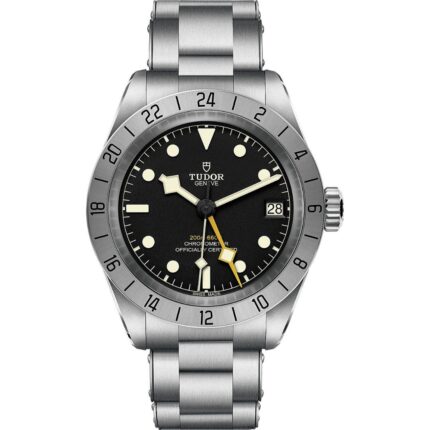 A front view of the Tudor Black Bay Pro watch on a stainless steel bracelet. It features a black dial with luminescent markers, a prominent yellow 24-hour hand, and a fixed stainless steel bezel with a 24-hour scale.