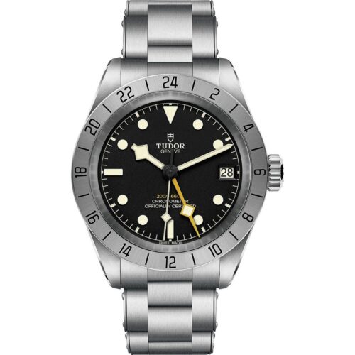 A front view of the Tudor Black Bay Pro watch on a stainless steel bracelet. It features a black dial with luminescent markers, a prominent yellow 24-hour hand, and a fixed stainless steel bezel with a 24-hour scale.